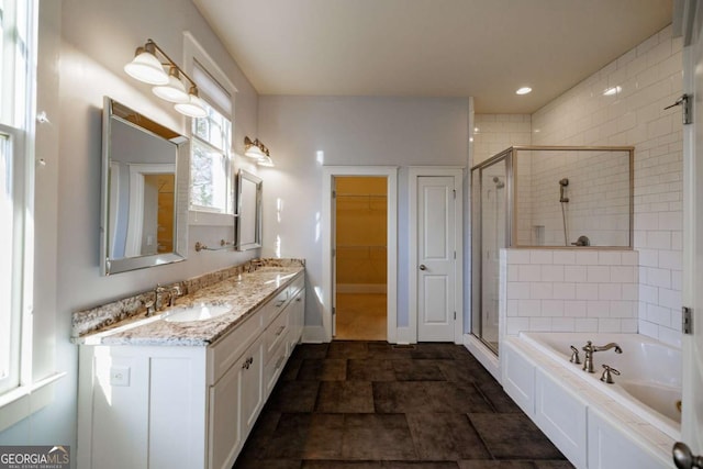 bathroom with vanity and shower with separate bathtub