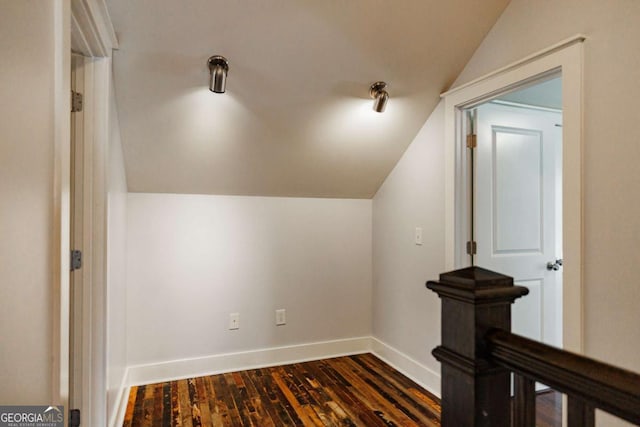 additional living space with dark hardwood / wood-style flooring and vaulted ceiling