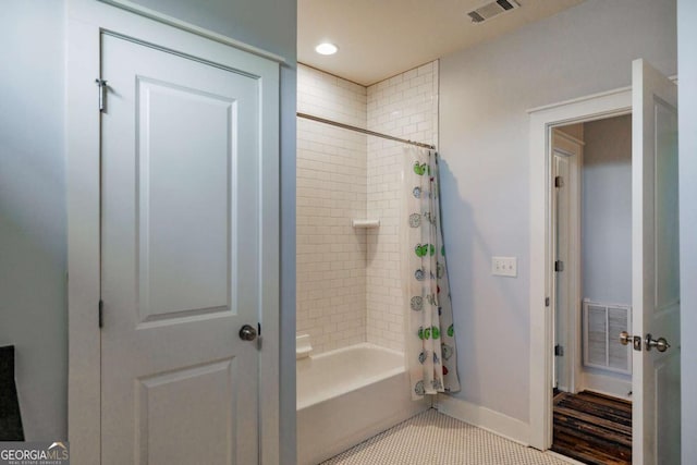 bathroom with shower / bathtub combination with curtain and tile patterned flooring