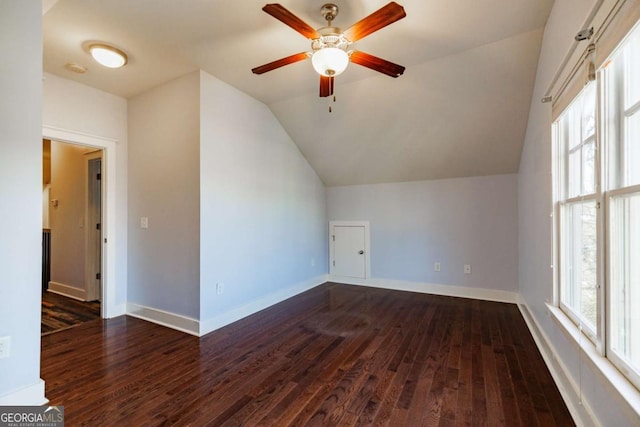 additional living space featuring dark hardwood / wood-style floors, vaulted ceiling, and ceiling fan