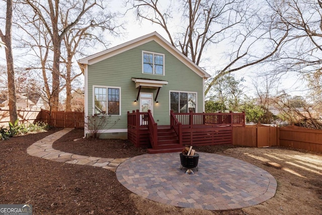 view of front of home featuring a deck and an outdoor fire pit