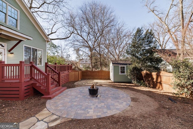 view of yard with a storage unit, a patio, and a fire pit