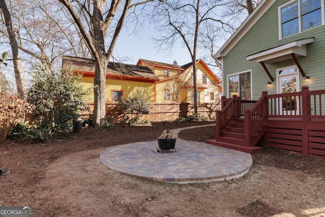 view of yard with a deck, a patio area, and a fire pit