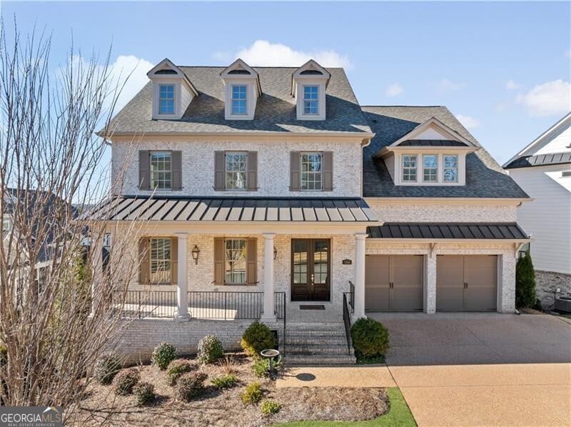 view of front facade featuring a porch and a garage