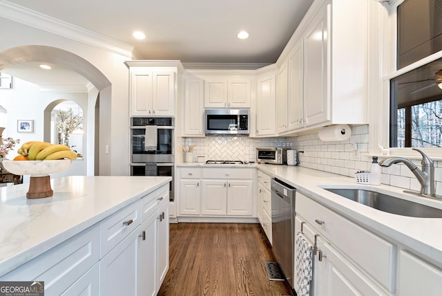 kitchen with appliances with stainless steel finishes, sink, and white cabinets