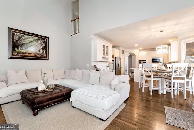 living room featuring dark wood-type flooring and ornamental molding