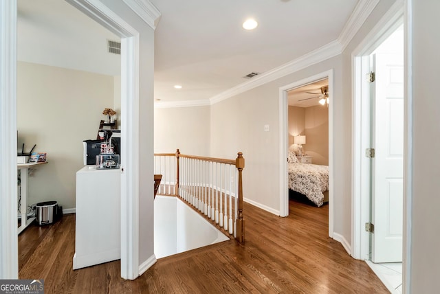 hallway with ornamental molding and dark hardwood / wood-style floors