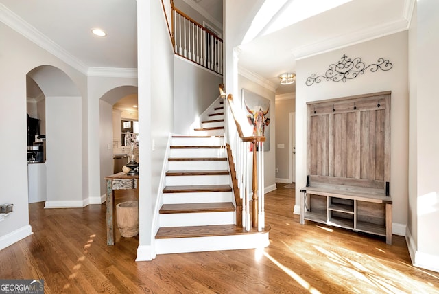 foyer entrance featuring hardwood / wood-style flooring and crown molding