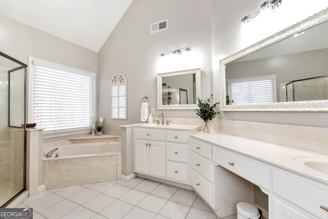 bathroom with tile patterned flooring, vanity, vaulted ceiling, and shower with separate bathtub