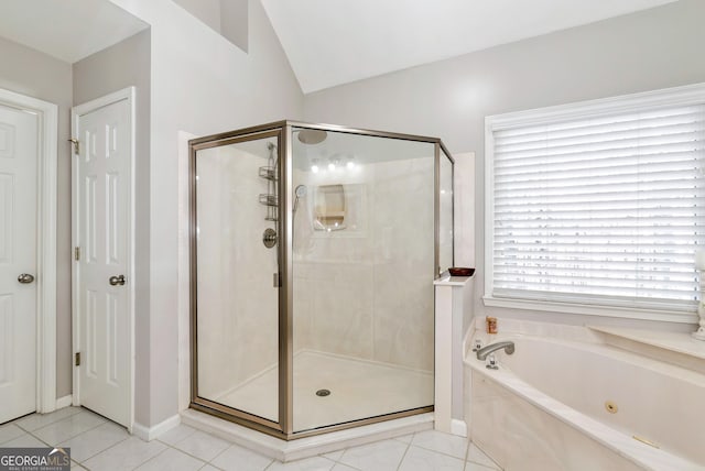 bathroom with tile patterned floors, shower with separate bathtub, and vaulted ceiling