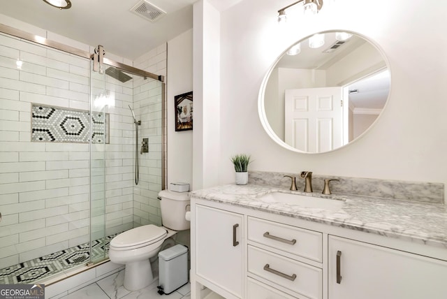 bathroom featuring vanity, toilet, and a shower with door