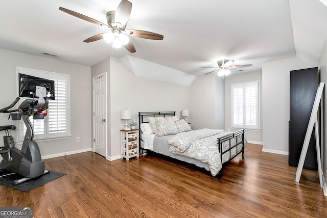 bedroom with multiple windows, dark wood-type flooring, lofted ceiling, and ceiling fan