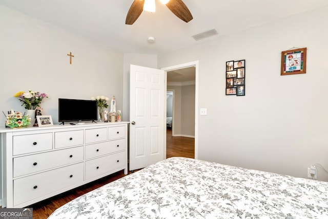 bedroom featuring ceiling fan and dark hardwood / wood-style floors