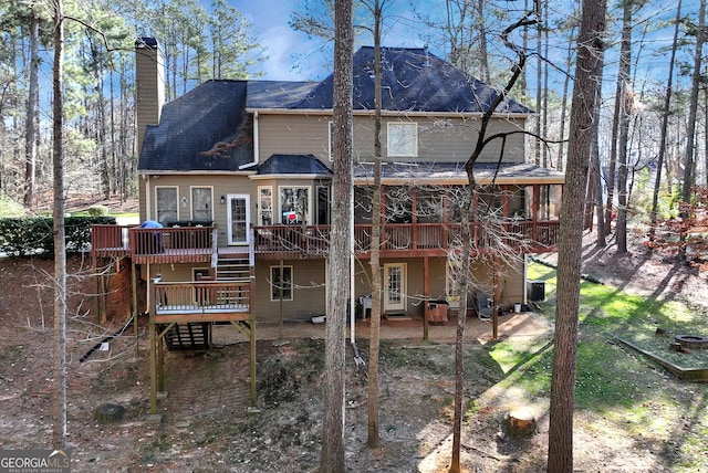 rear view of property featuring a patio and a deck