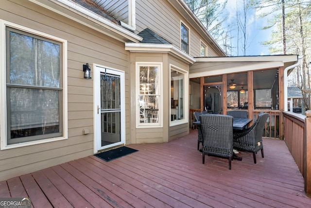 wooden terrace featuring a sunroom