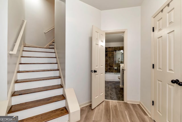 staircase featuring hardwood / wood-style flooring