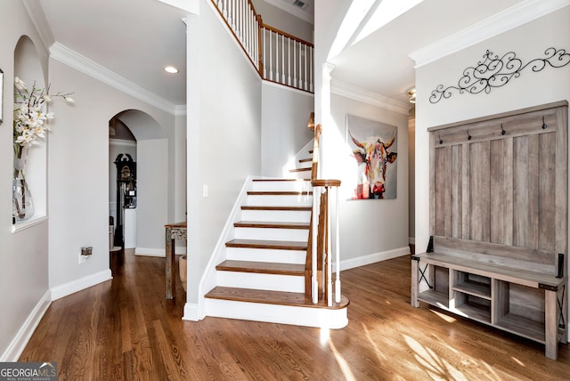 entrance foyer featuring ornamental molding and dark hardwood / wood-style flooring