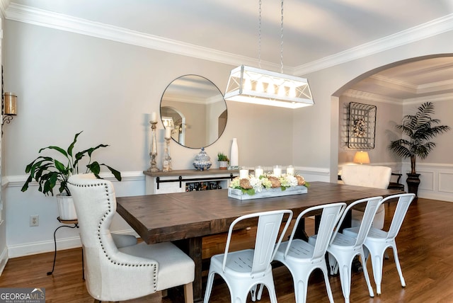 dining space featuring ornamental molding and dark hardwood / wood-style flooring