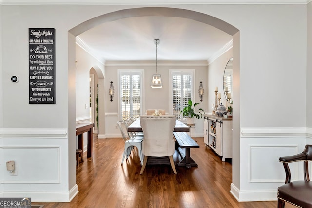 dining space with ornamental molding and wood-type flooring