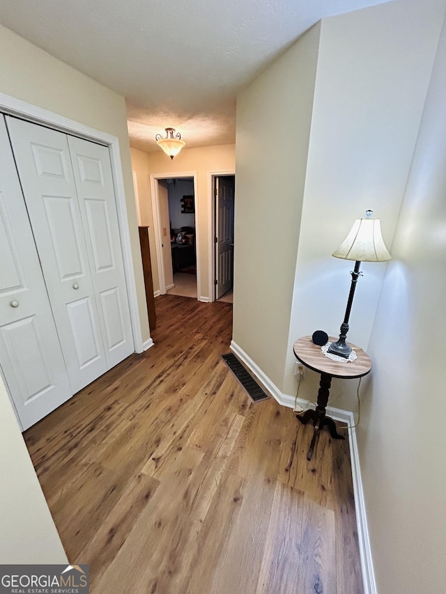 corridor featuring hardwood / wood-style floors