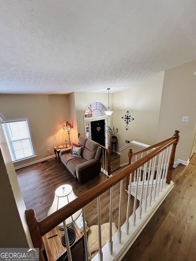 living room featuring a textured ceiling and dark hardwood / wood-style flooring