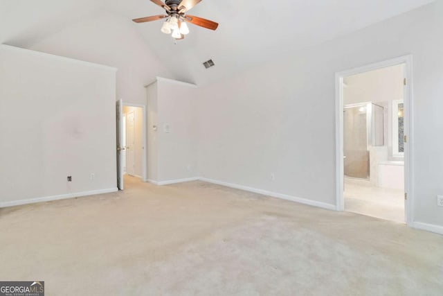 unfurnished bedroom featuring high vaulted ceiling, light colored carpet, ensuite bath, and ceiling fan