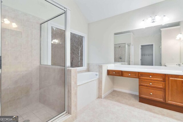 bathroom with plus walk in shower, tile patterned floors, lofted ceiling, and vanity