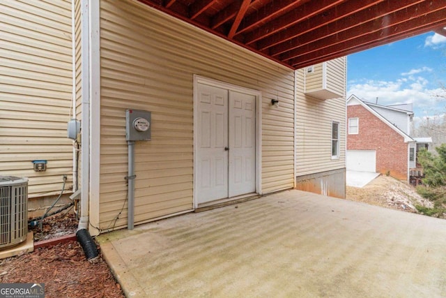 entrance to property with a patio and central AC