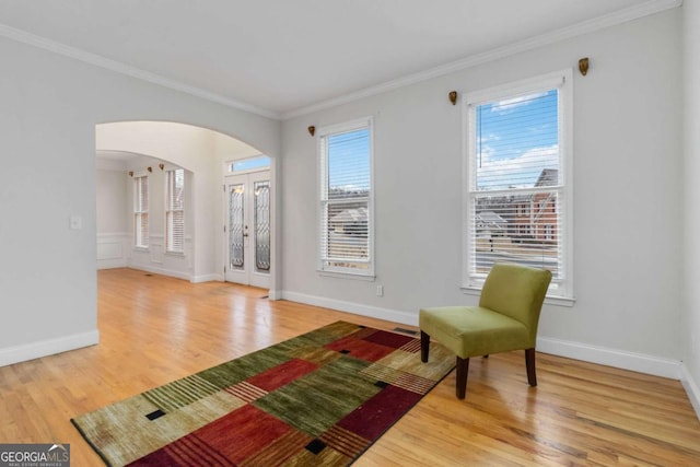 living area featuring crown molding and wood-type flooring