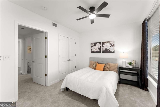 carpeted bedroom with a closet and ceiling fan