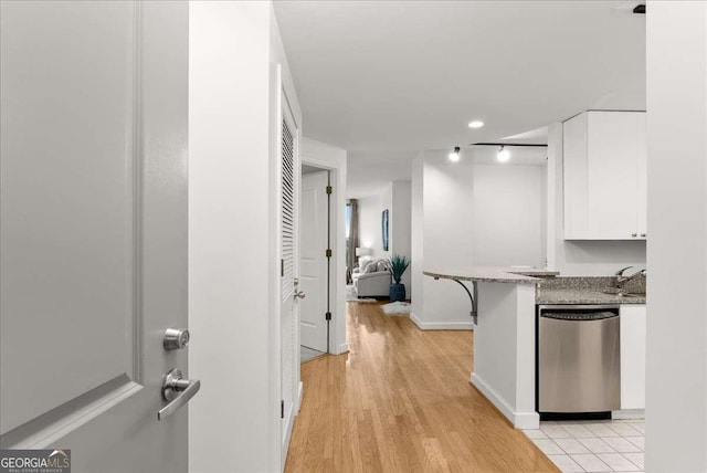 hallway featuring sink and light hardwood / wood-style flooring