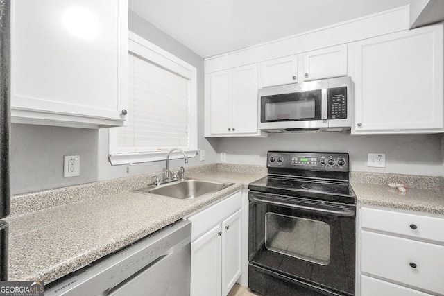 kitchen with sink, white cabinetry, and stainless steel appliances