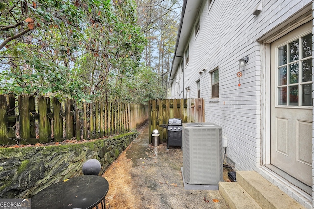 view of patio featuring area for grilling and cooling unit