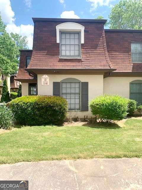 view of side of home with a lawn