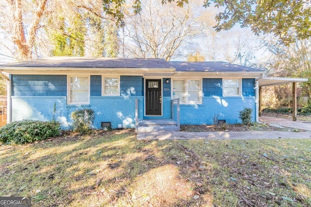 single story home with a front yard and a carport