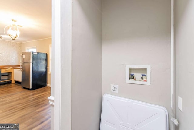 laundry room with washer hookup, hardwood / wood-style floors, and crown molding