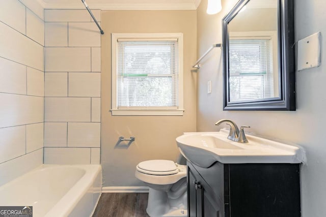 full bathroom with toilet, vanity, crown molding, and a healthy amount of sunlight