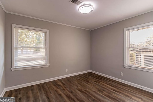 empty room with dark hardwood / wood-style floors and ornamental molding