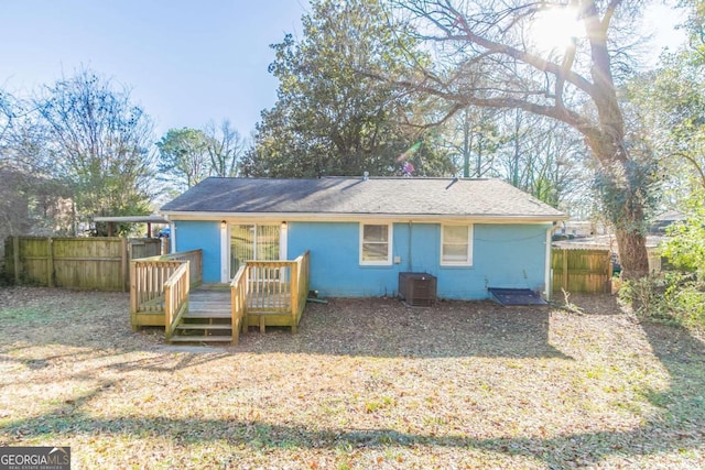 back of property with a wooden deck and cooling unit