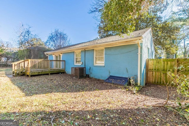 rear view of property featuring central AC unit and a deck