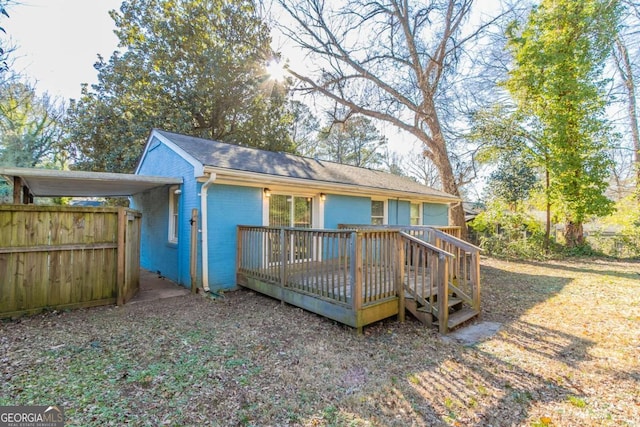 rear view of house featuring a wooden deck