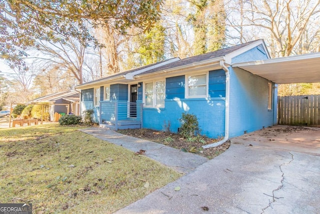 ranch-style house with a front lawn and a carport