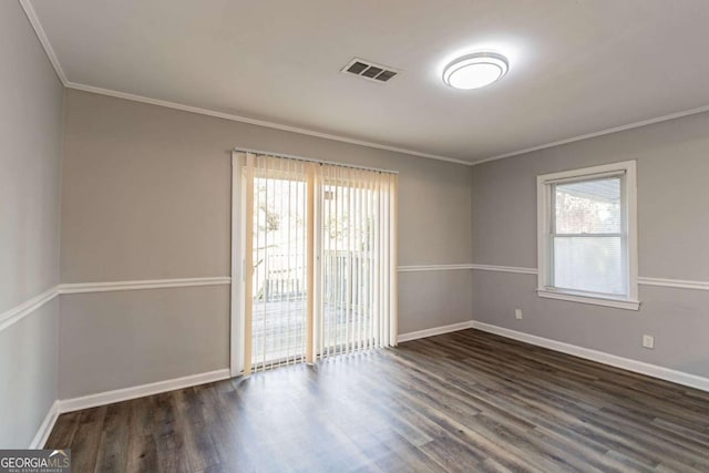 spare room featuring dark wood-type flooring and ornamental molding