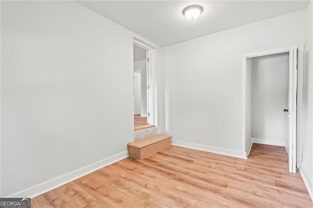 spare room with light wood-type flooring