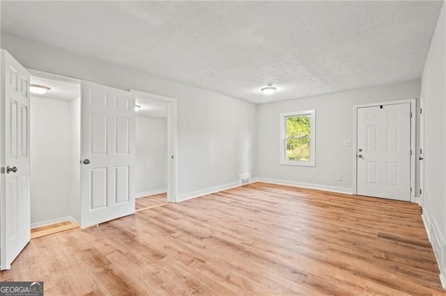 empty room with light hardwood / wood-style floors