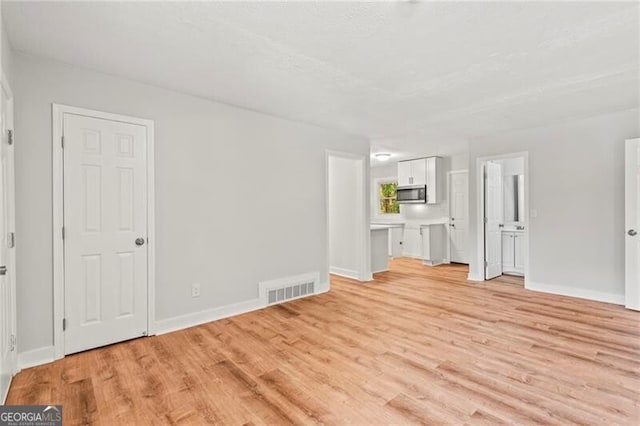 unfurnished living room featuring light hardwood / wood-style floors