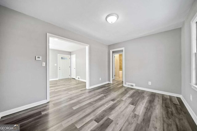unfurnished room featuring hardwood / wood-style floors