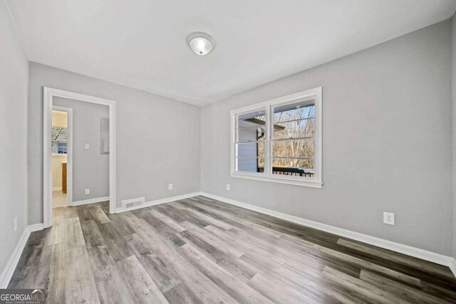 spare room featuring light wood-type flooring