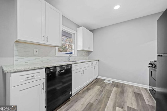 kitchen with sink, white cabinets, dishwasher, and light stone countertops