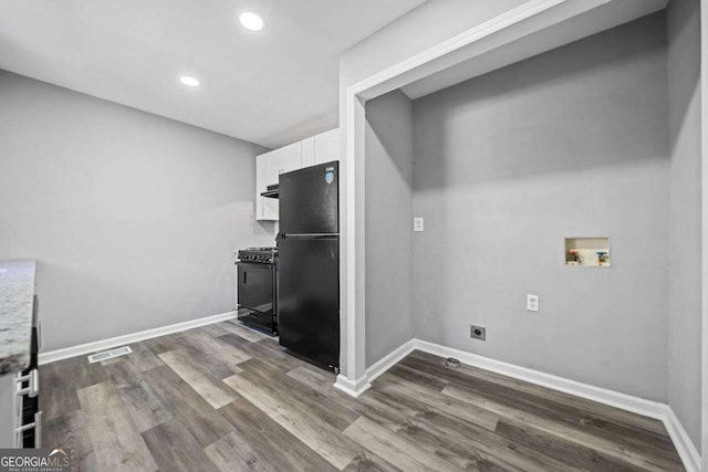laundry area featuring dark wood-type flooring, hookup for a washing machine, and hookup for an electric dryer